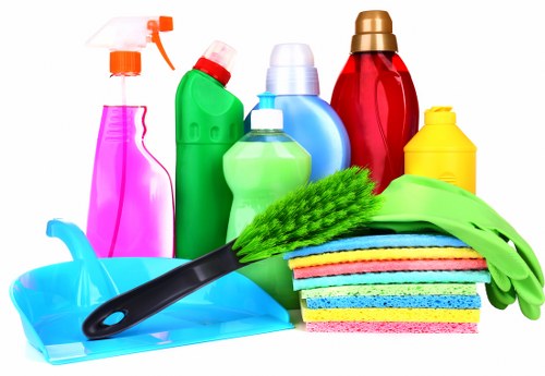 A cleaner in SW2 preparing cleaning tools for a property